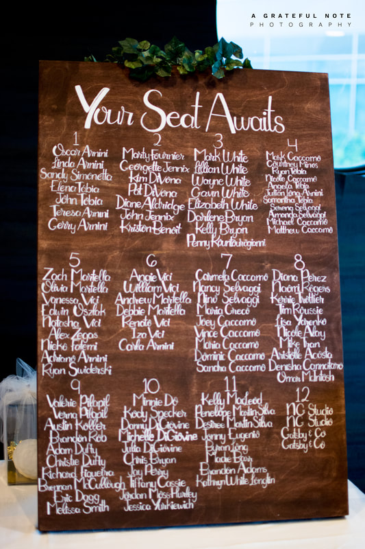 Do-It-Yourself Wedding Calligraphy Seating Chart on Stained Dark Wood Panel