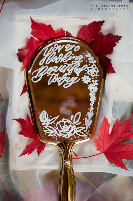 Calligraphy Quote "You are looking Beautiful today" on Antique Gold Hand Mirror with Botanical Embellishment - Close Up with Japanese Red Maple Leaves
