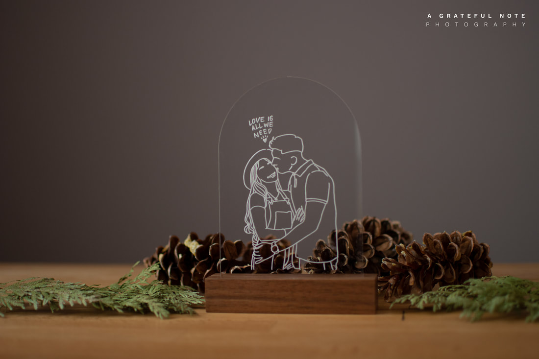 Minimalist Portrait Illustration engraved on clear acrylic frame with dark wood stand