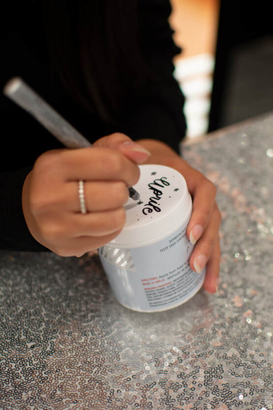 Toronto Event Calligrapher writes name on a cream jar at Sephora Canada