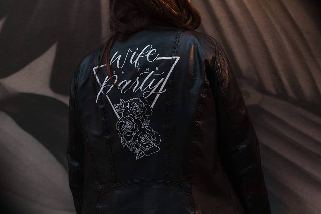 Bride wears a Black Leather Jacket with Calligraphy Quote 